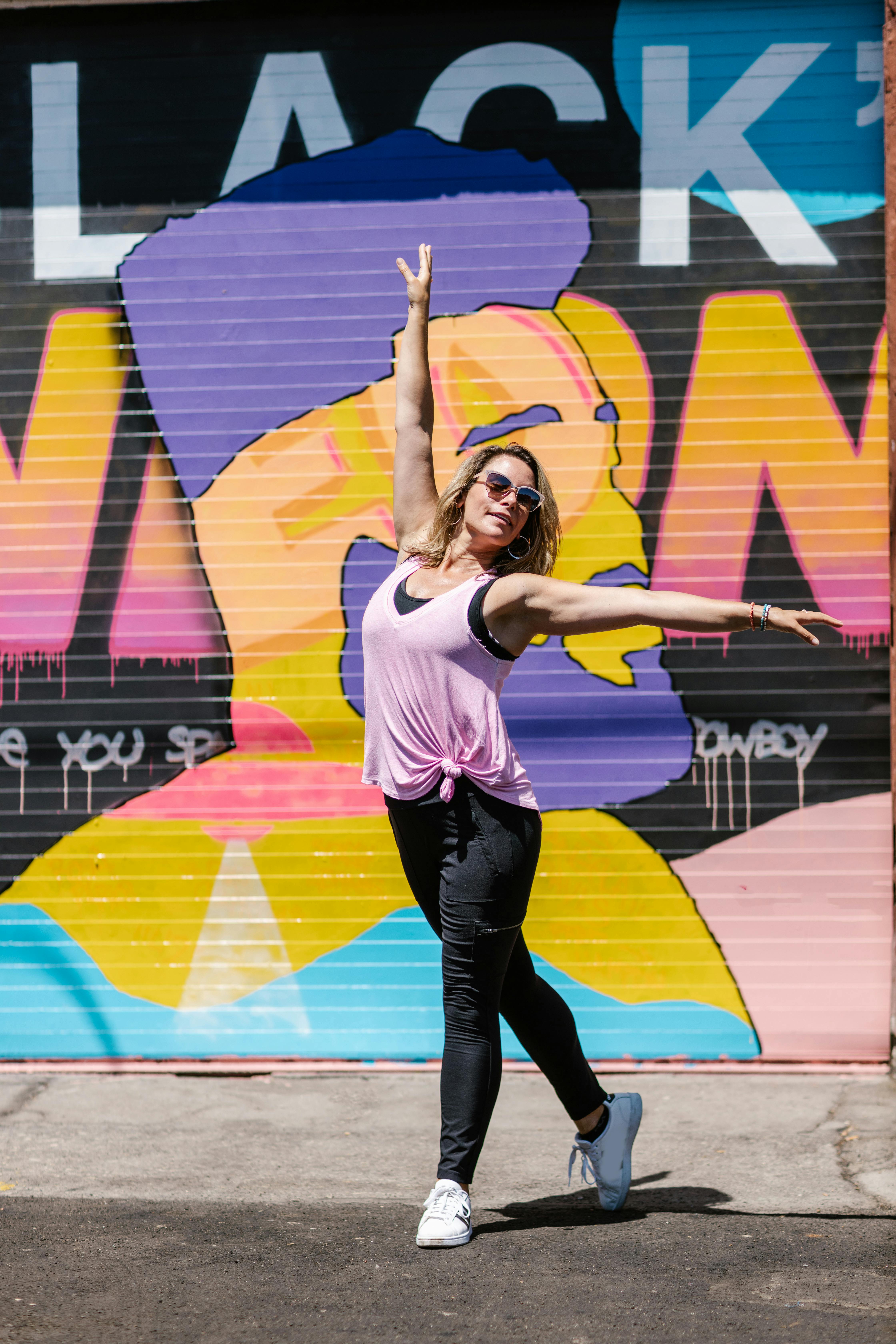 Woman in Yellow Tank Top and Blue Denim Shorts Dancing · Free Stock Photo