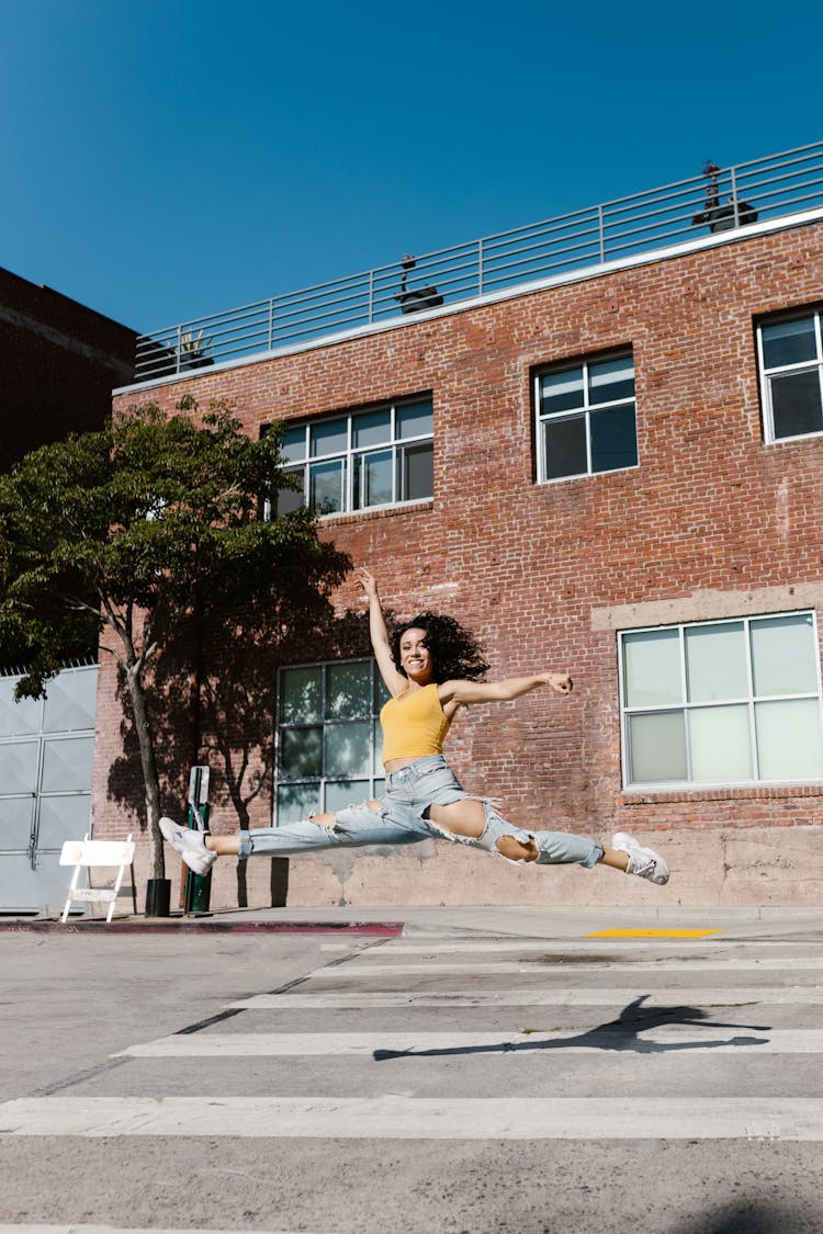 A Young Woman Dancing In The Street