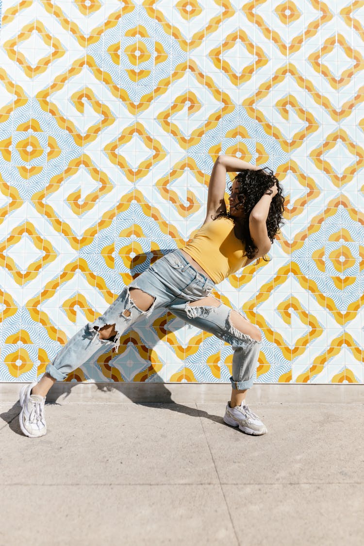 A Woman Posing By A Mosaic Wall