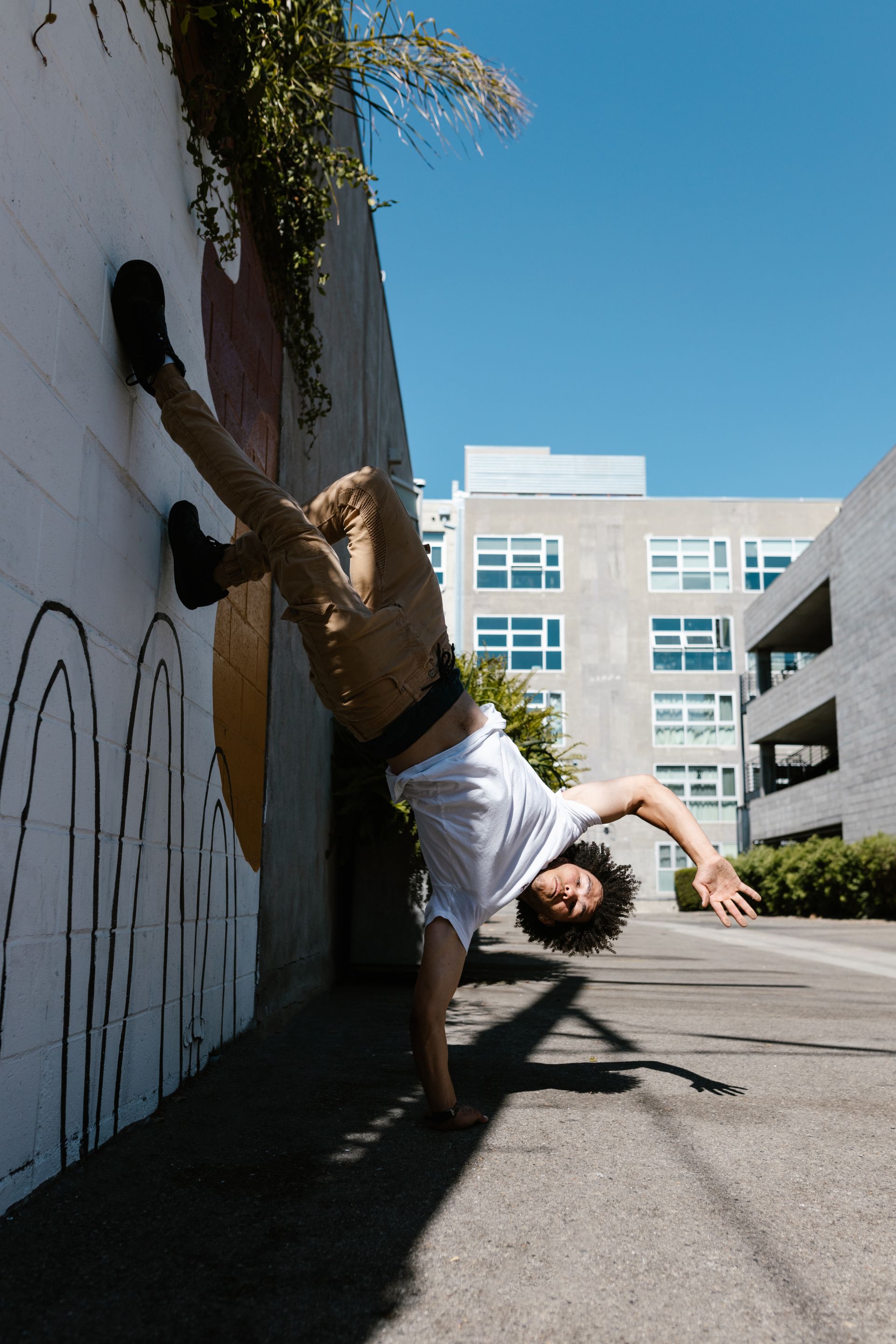 Street dancer performing a handstand, representing the entertainers and creatives in Jon's network