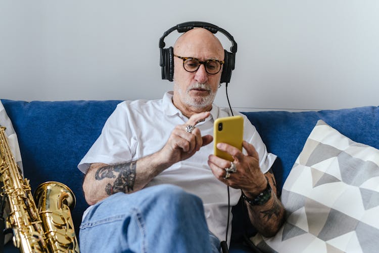 Man With Headphones Using A Cellphone