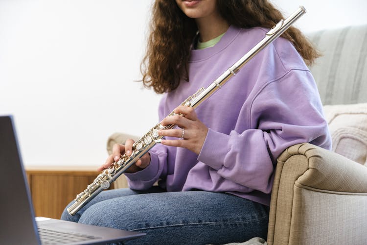 Woman In Purple Sweater Holding A Flute