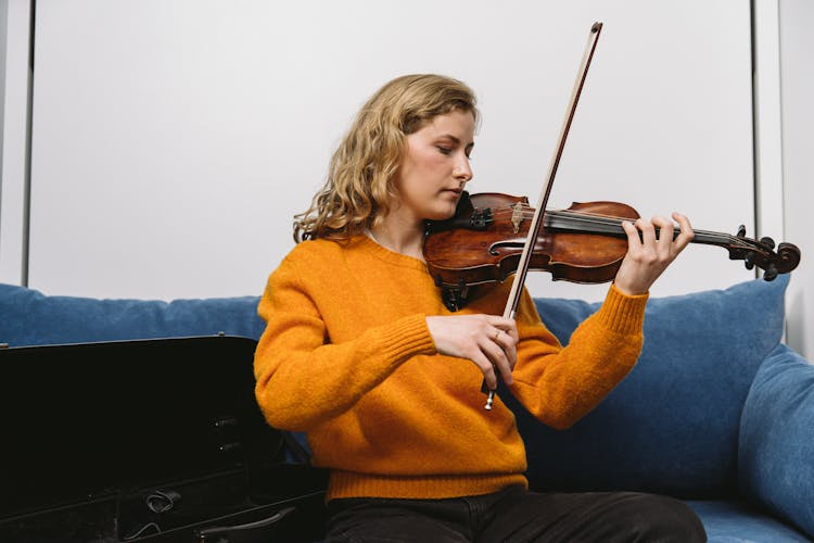 A Violinist On A Blue Sofa