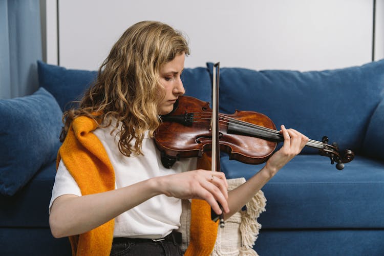 A Woman Playing A Bowed String Instrument