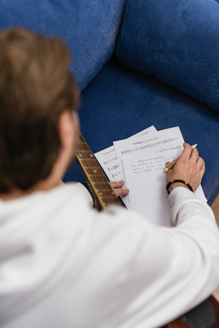 Person With A Guitar Writing  Notes