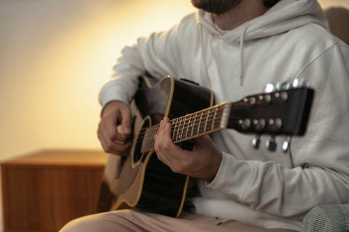 Free  A Person Playing a Guitar Stock Photo