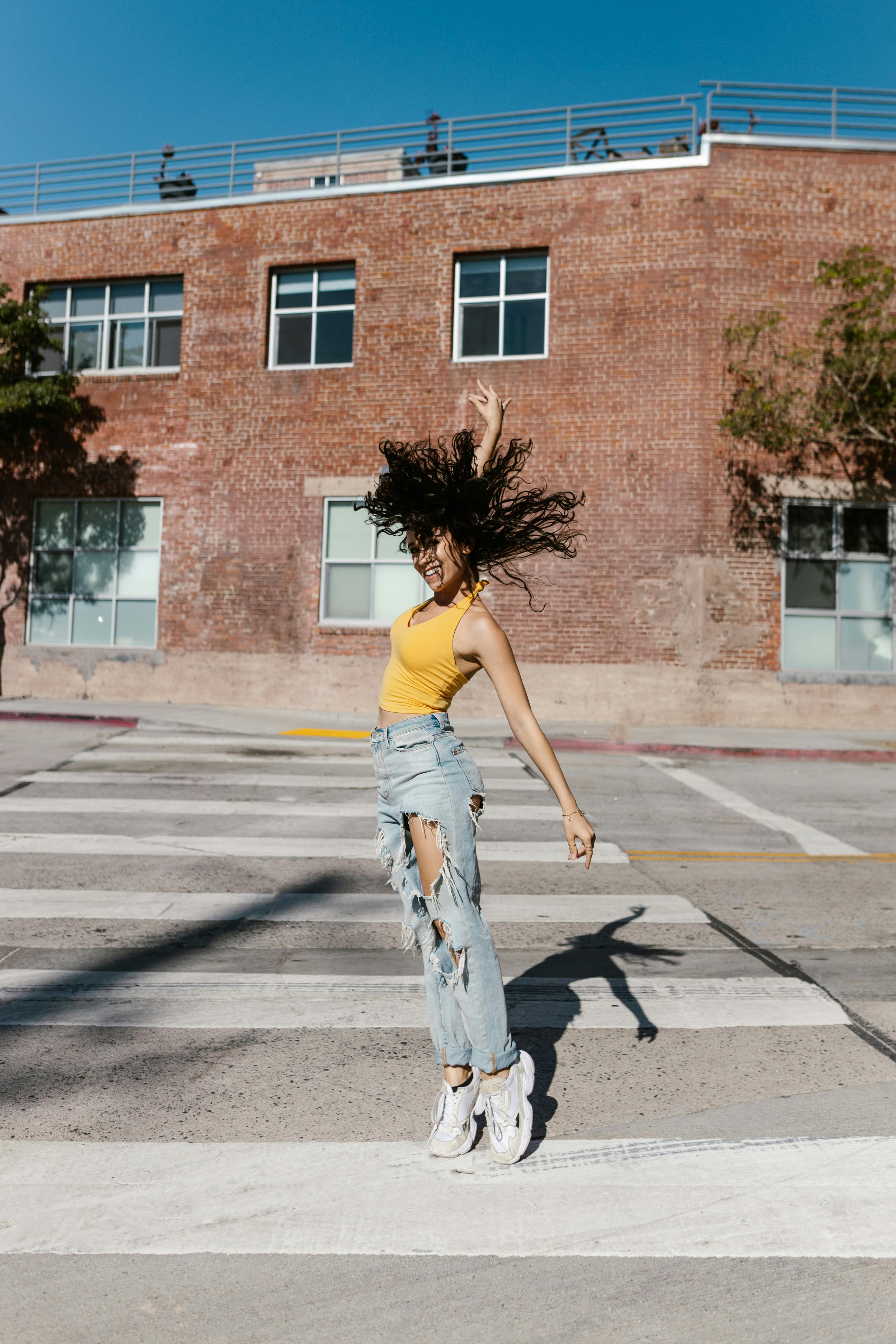 Model Posing in Ripped Jeans · Free Stock Photo