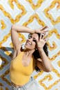 Woman in Yellow Tank Top Wearing Eyeglasses