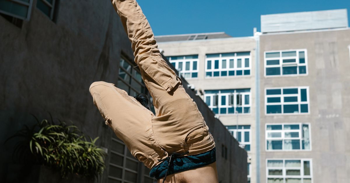 Head Stunts A Man in White Shirt Doing Head Stunt · Free Stock Photo