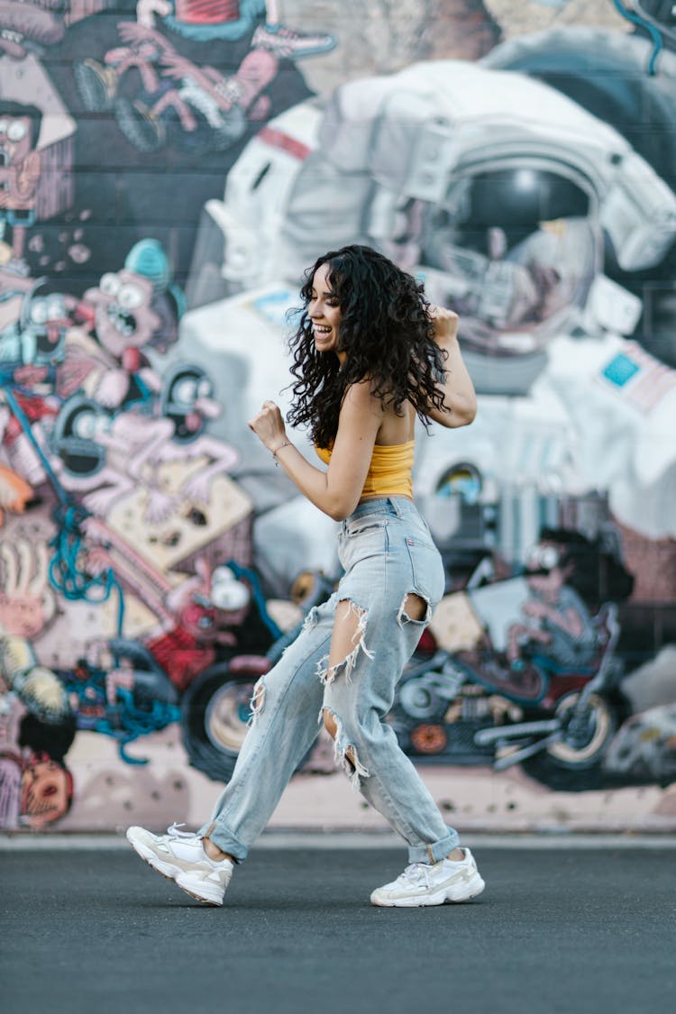 A Happy Woman Dancing On The Street