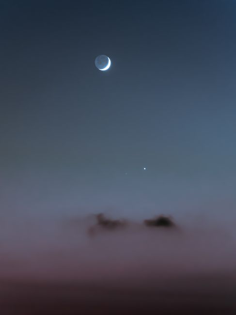 Crescent moon and stars in a tranquil night sky, perfect for serene wallpapers.