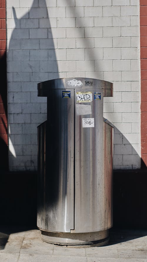 Silver Trash Bin Beside White Wall