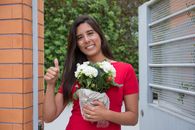 Woman in Red Crew Neck T-shirt Holding Bouquet of Flowers