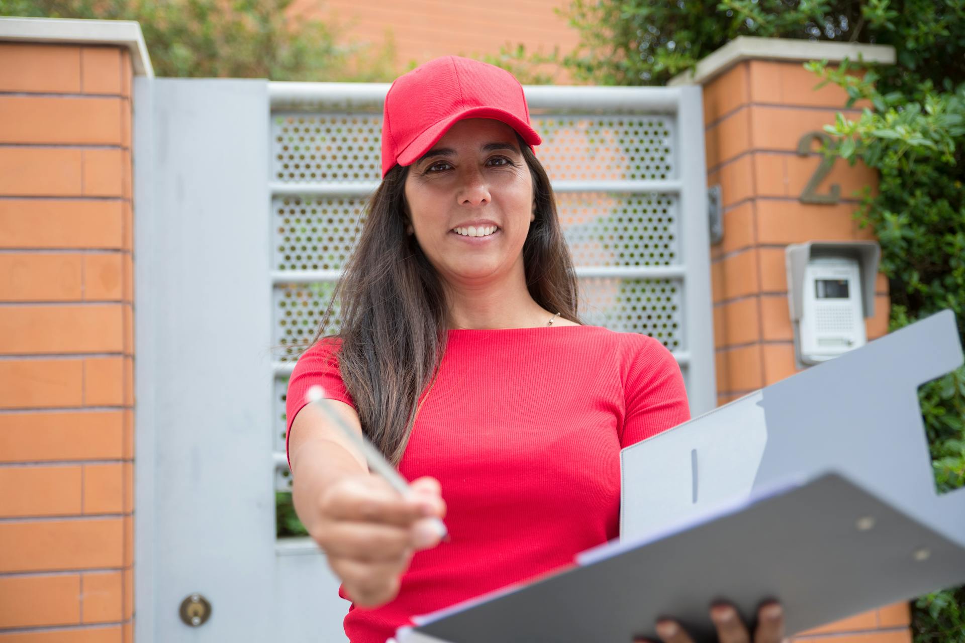 A Delivery Person Holding a Pen and a Clipboard