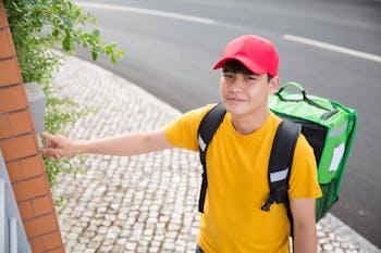 A Delivery Man Clicking the Doorbell while Looking at the Camera