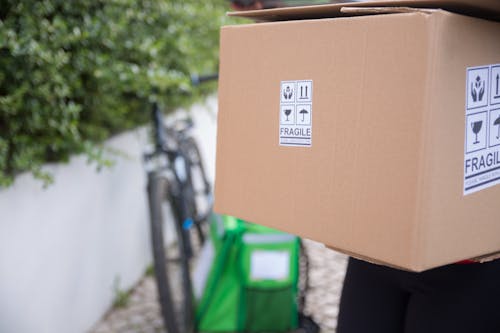 Free Brown Cardboard Box With Sign in Close-up Photography Stock Photo
