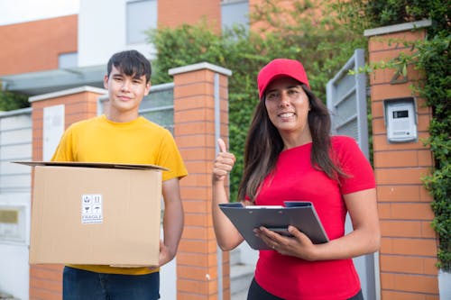 Woman Wearing a Red Shirt Delivering a Package