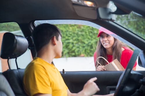 Man in Yellow Shirt Sitting inside the Car