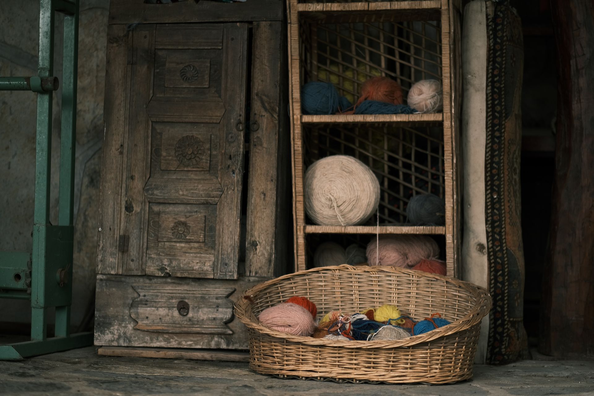 A rustic display of colorful yarn balls stored in wicker baskets and shelves. Cozy and creative ambiance.