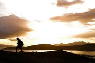 Silhouette of Man Carrying Backpack while Walking During Golden Hour
