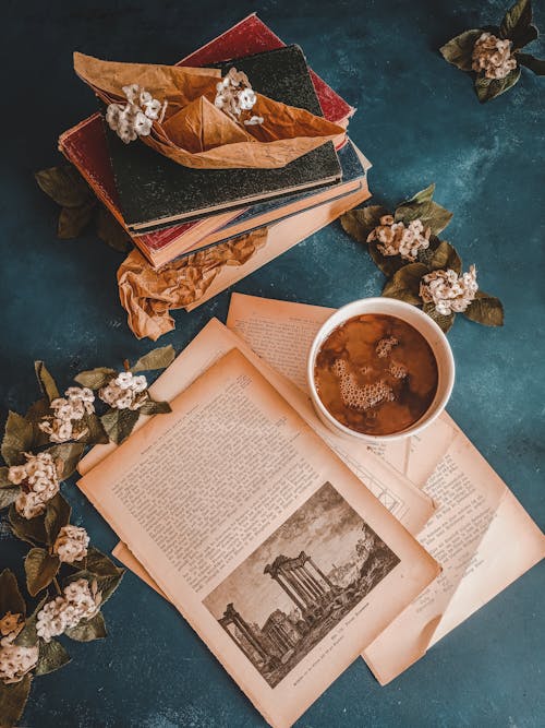 Free Overhead Shot of a Stack of Books and Coffee Stock Photo