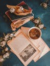Overhead Shot of a Stack of Books and Coffee