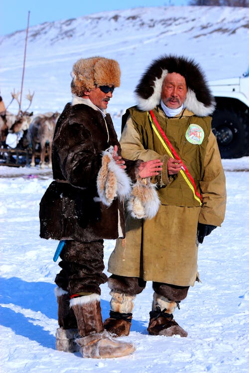 Two Senior Inuits Talking Outdoors