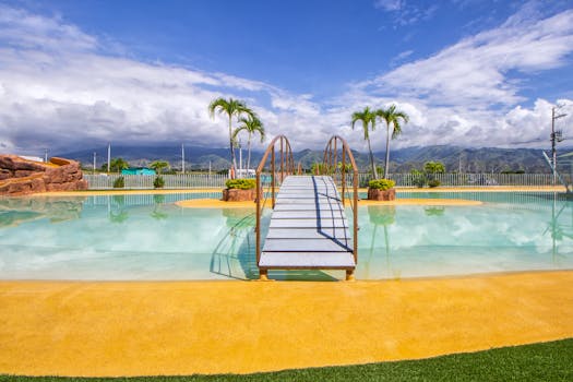 Idyllic tropical swimming pool with a picturesque bridge, perfect for a relaxing vacation.