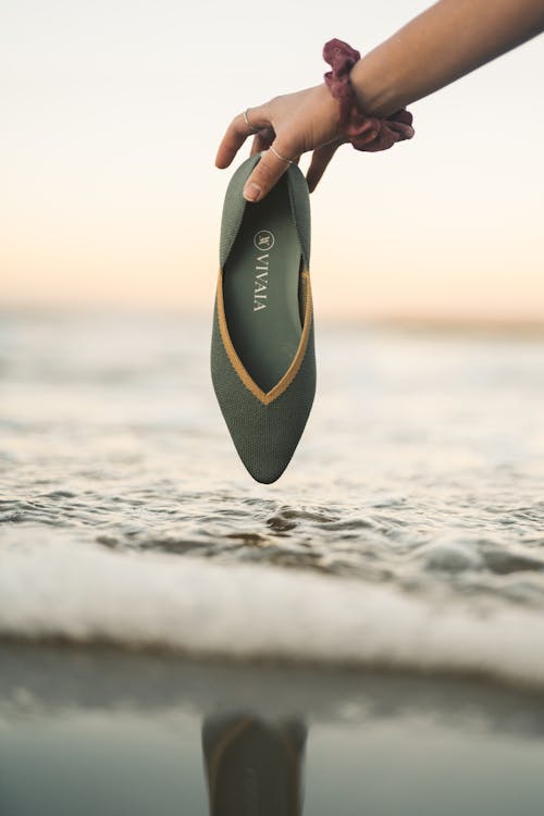 Close-Up Shot of a Person Holding a Sandal