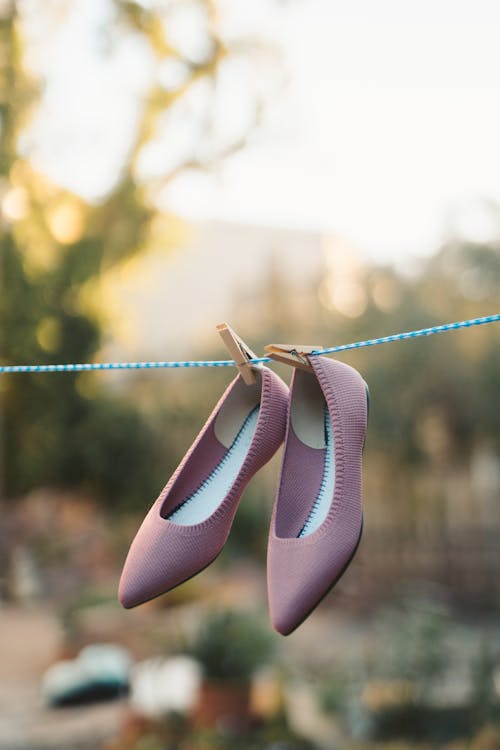 Pair of Purple Flat Shoes Hanging on a Clothesline