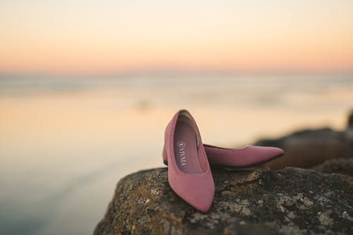 Close-Up Shot of Pink Sandals on a Rock