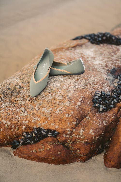 Gray Slip on Sandals over the Rock