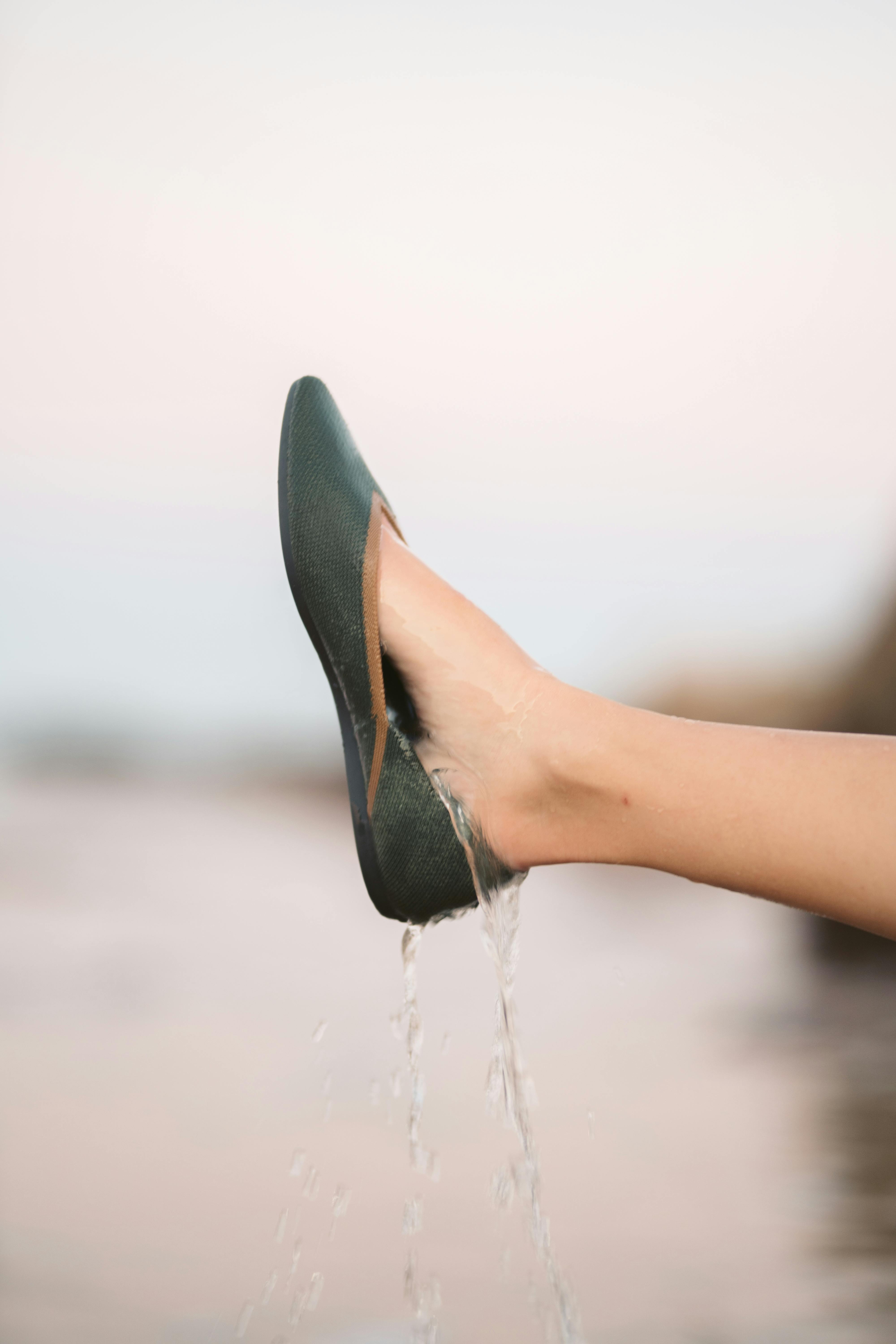 person wearing black leather pointed toe pumps