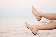 A Person Wearing Wet Brown Shoes
