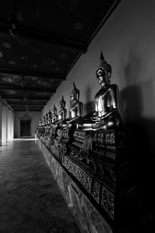 Grayscale Photo of Buddha Statues