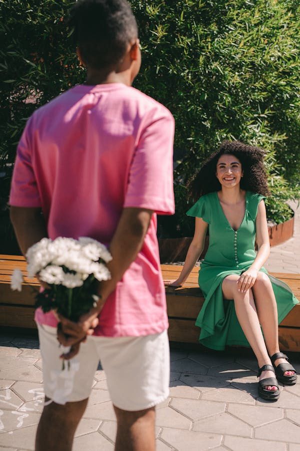 Man in Red Polo Shirt Holding Woman in White Dress