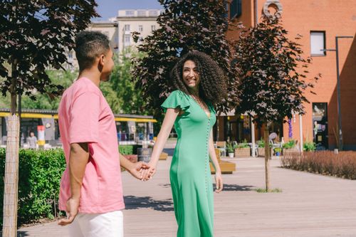 Free Smiling couple enjoying a walk outdoors on a sunny day. Stock Photo