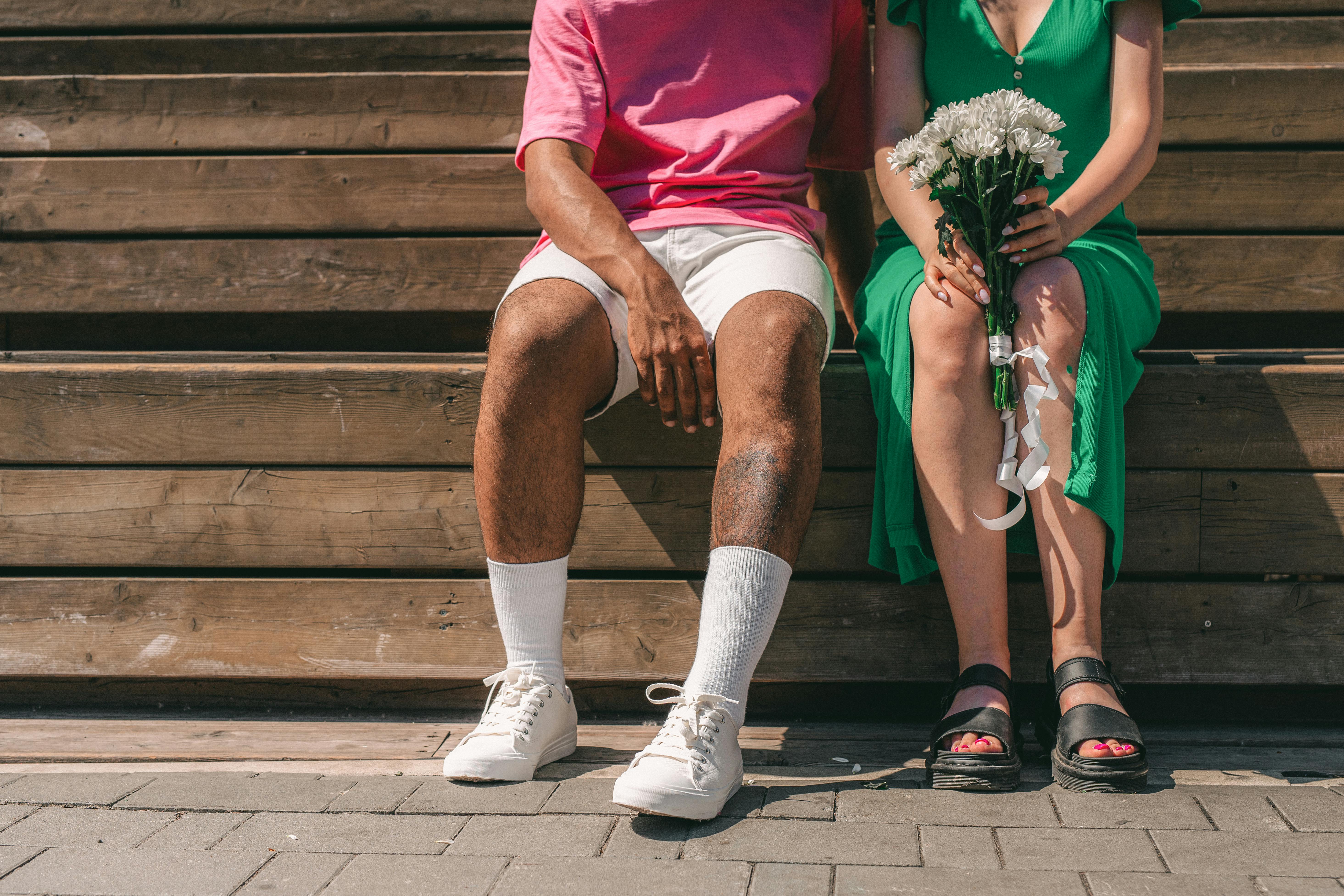 a couple sitting on wooden bench