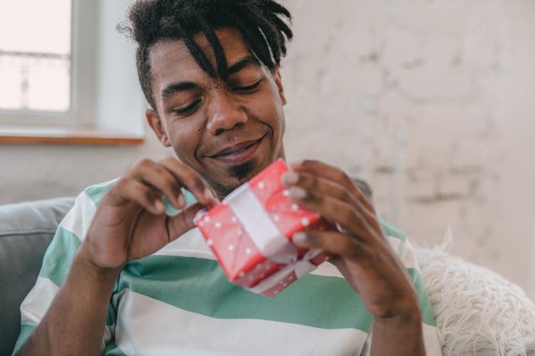 A Man Opening A Gift