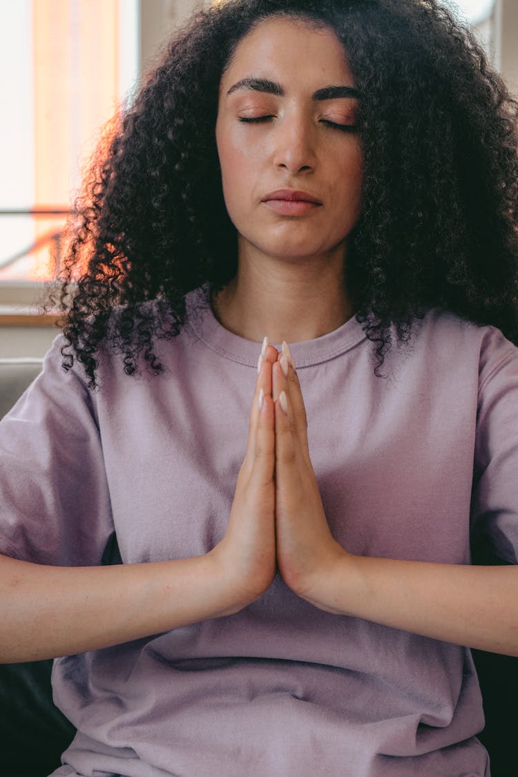 A Curly Haired Woman Praying 