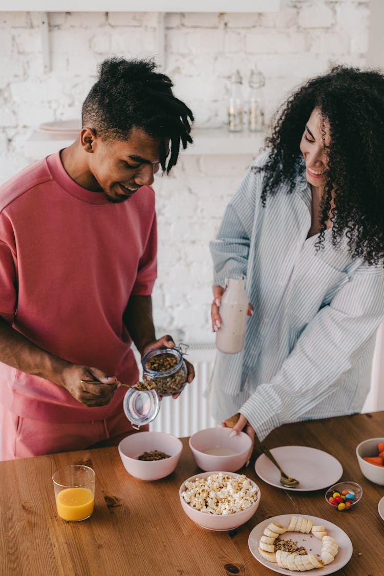 Happy Couple Preparing Their Food 