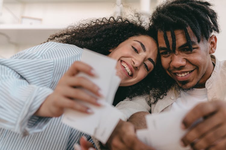 A Couple Happily Looking At Memorable Photographs