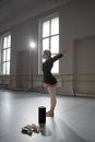 Woman in Black Long Sleeve Shirt and Purple Skirt Doing Stretching
