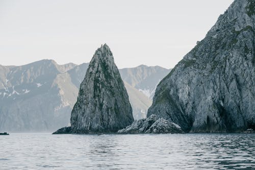 Gray and White Mountains Beside the Body of Water