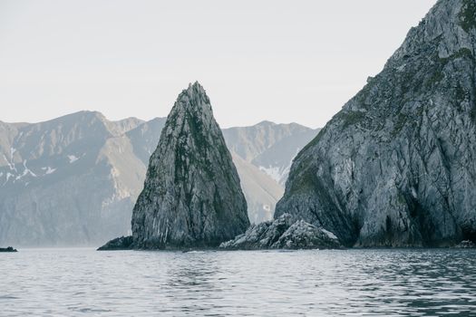 Gray and White Mountains Beside Body of Water