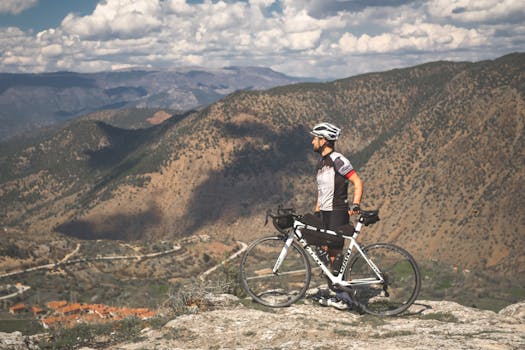 Cyclist enjoys panoramic mountain views in Türkiye, showcasing adventure and freedom.