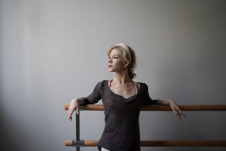 Woman Leaning On The Railing 