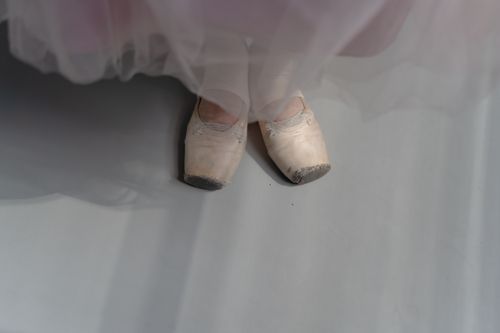 Free Close-up of ballet shoes on a dancer's feet, capturing the grace and elegance of ballet. Stock Photo
