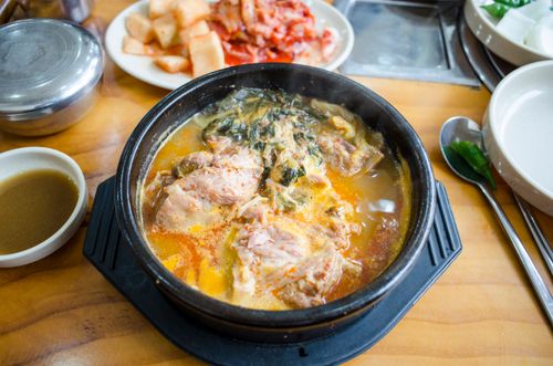 A flavorful Korean soup served hot with kimchi and vegetables, perfect for a hearty meal.