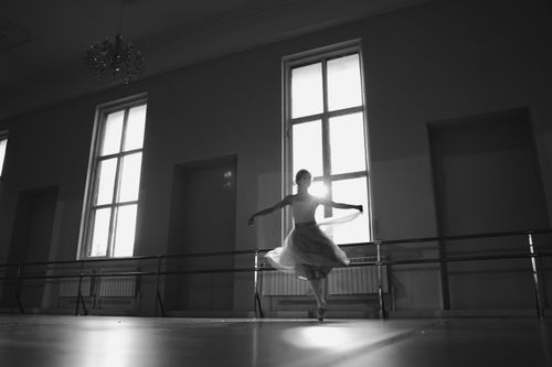 Free Elegant ballerina dancing gracefully in monochrome studio lighting. Stock Photo